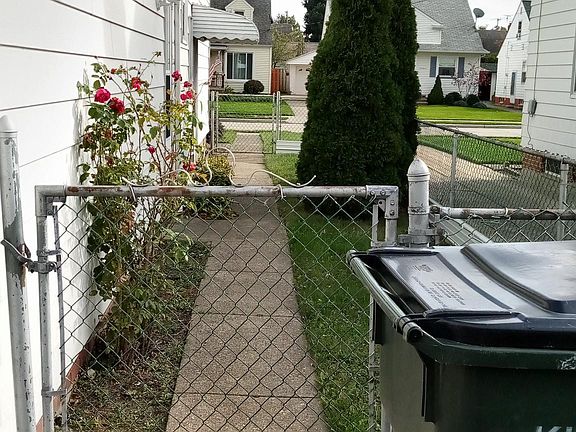 Small fenced in area. Door entrance to garage and side entrance to house.