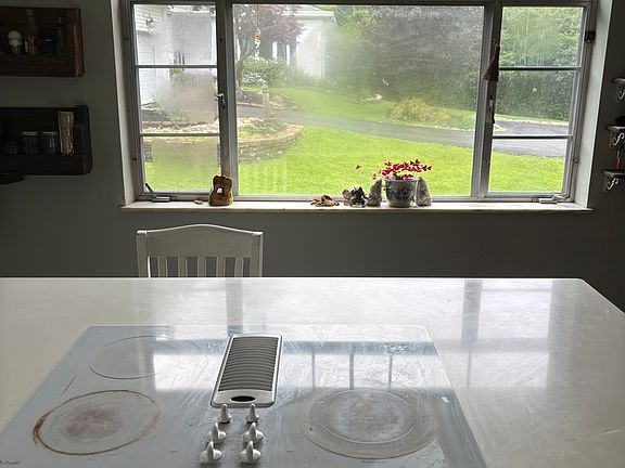 Fully renovated kitchen with quartz countertops, built in microwave, large farmhouse sink.