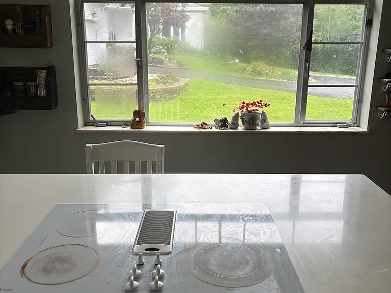 Fully renovated kitchen with quartz countertops, built in microwave, large farmhouse sink.