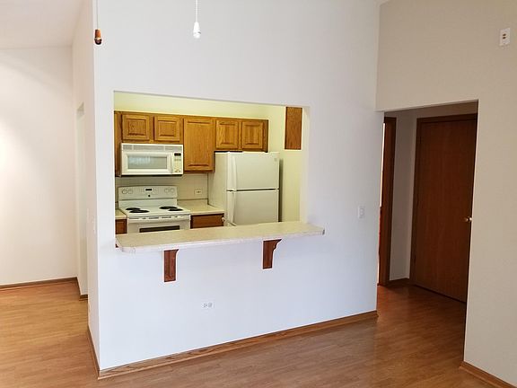 Peek into kitchen and hall from vicinity of patio door to ba