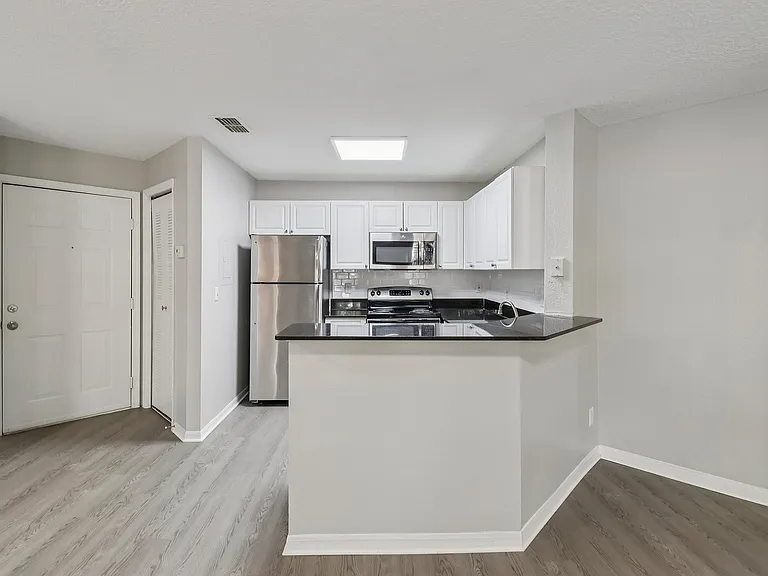 Modern kitchen with sleek finishes and convenient breakfast bar