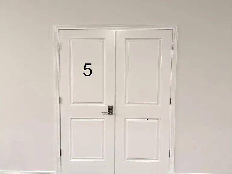 Entry area with double doors, durable tile flooring, and a keypad lock for convenient keyless access.