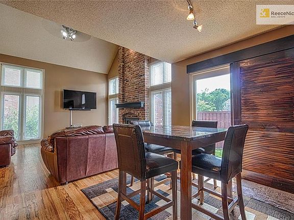 Dining area has louvered sliding barn door style doors leading out to private patio.