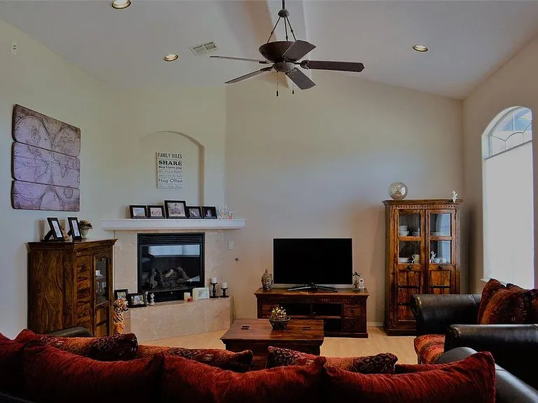 Living Room with gas fireplace, recessed lighting, surround sound hook-ups, and cathedral ceiling.
