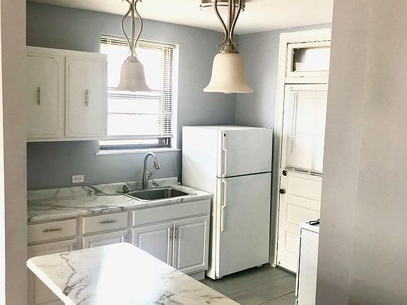 Breakfast bar with new, hanging light fixtures. 