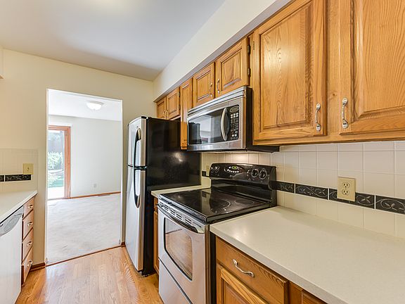 Updated kitchen with corian counter tops, stainless steel appliances and wood flooring.