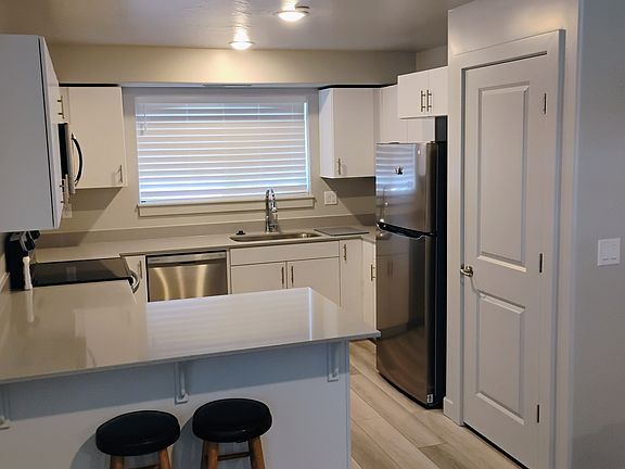 Full kitchen with bar. Enough room to seat 3. Oven, microwave, dishwasher, refrigerator, disposal, and large pantry for sufficient storage space.