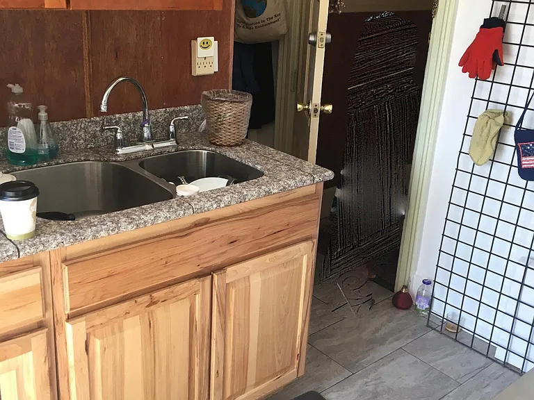 Kitchen sink and apt. entry from hallway.