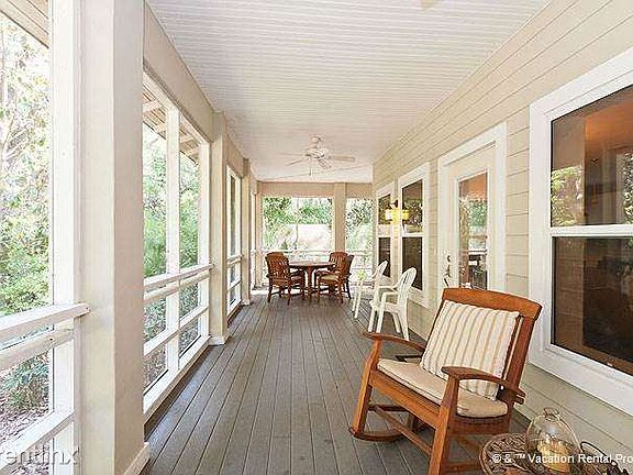 Rock your cares away on the spacious outdoor screened porch