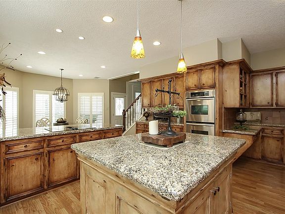 Huge island in center has space to prepare, serve on, additional storage space below, and overhang at end for additional seating. Kitchen Aid double oven and warming drawer very accessible to all areas. Even more cabinetry and counter space shown.