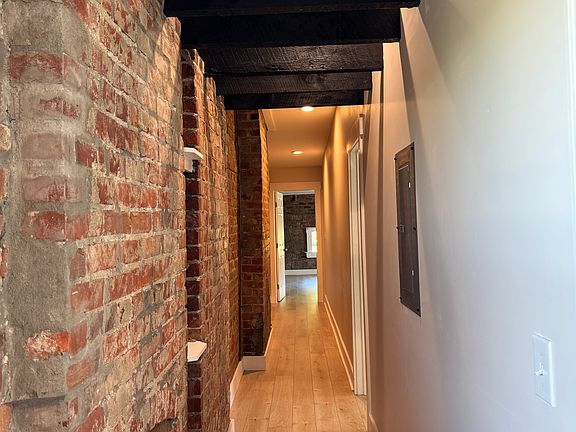 Hallway from kitchen to two equally large bedrooms