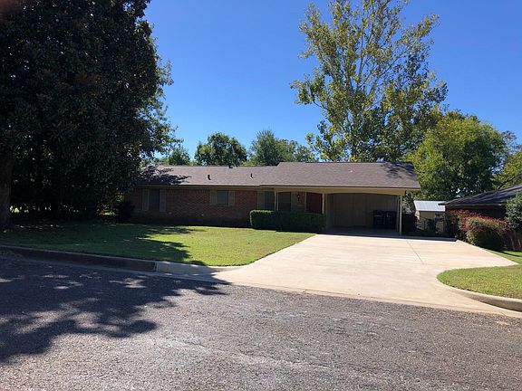Carport and adjacent concrete parking pad.