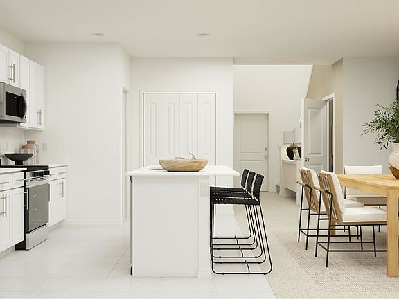 Enjoy a sleek, modern kitchen featuring a walk-in pantry and convenient adjacent laundry room.