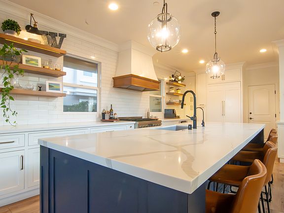 Quartz countertops, soft close cabinets, built-in refrigerator, top of the line appliances.