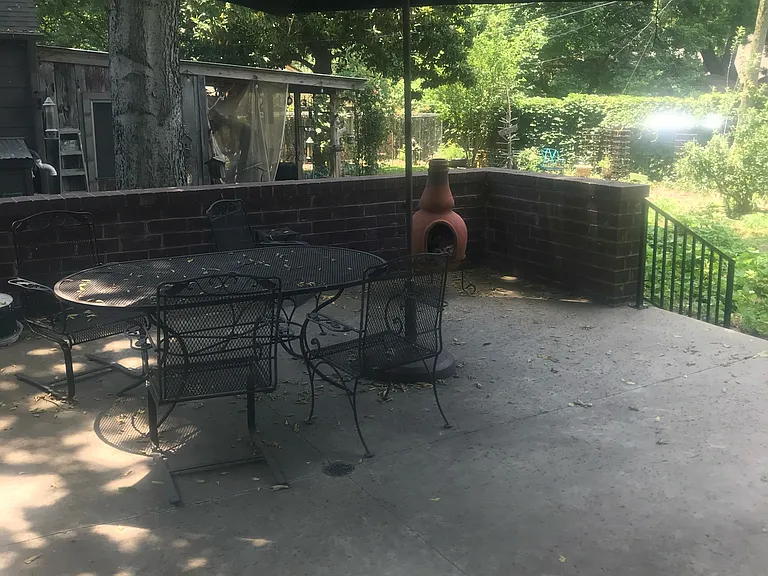 Spacious back patio overlooking the landscaped backyard