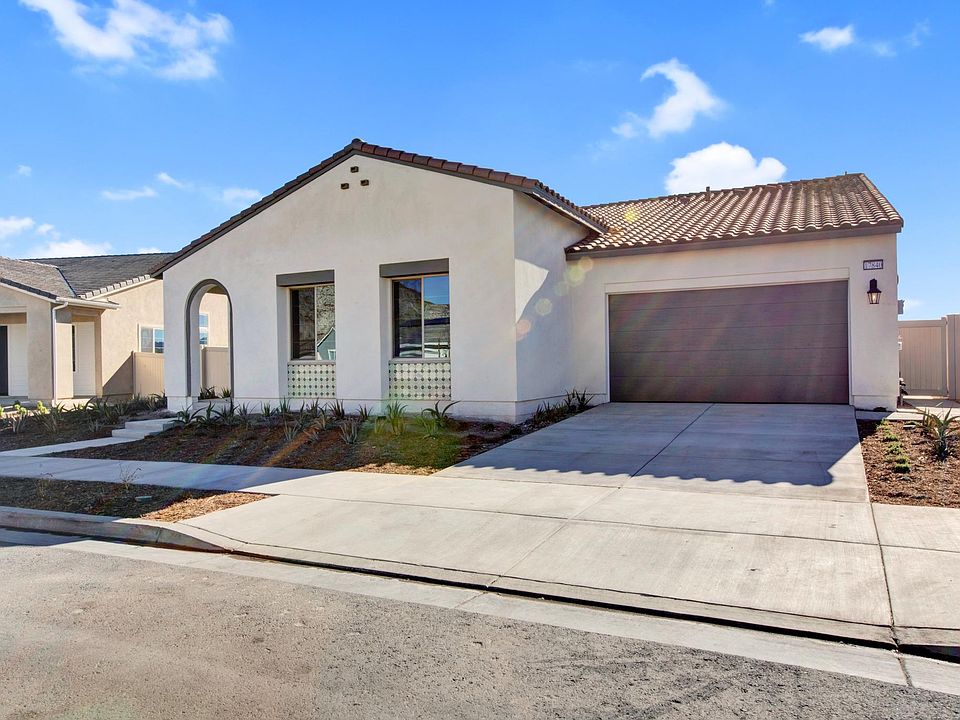 brand new single story home in with solar panels on top of hill in gated community with panoramic views