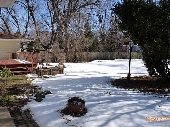 Fenced backyard with deck