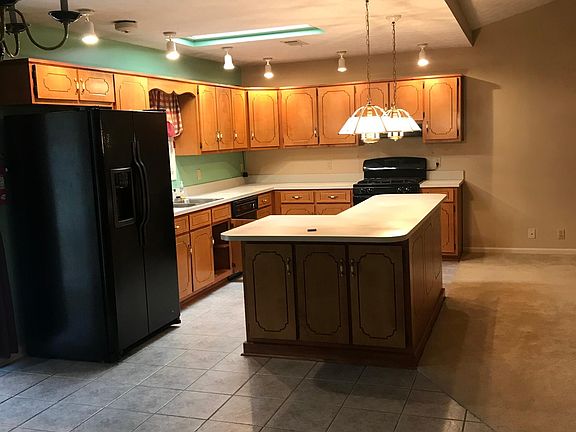 Big open floor plan. Kitchen, Living room, Dining room. Nice large kitchen area, side-by-side fridge, dishwasher, gas stove.