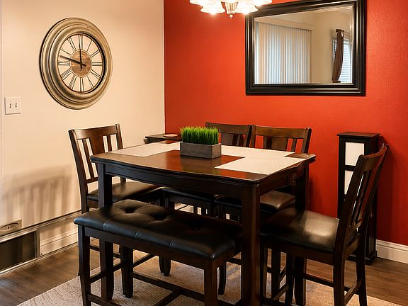 Dining room (includes: large table which expands for more space, four chairs, and a two-seater bench, two additional chairs at the bar off camera)