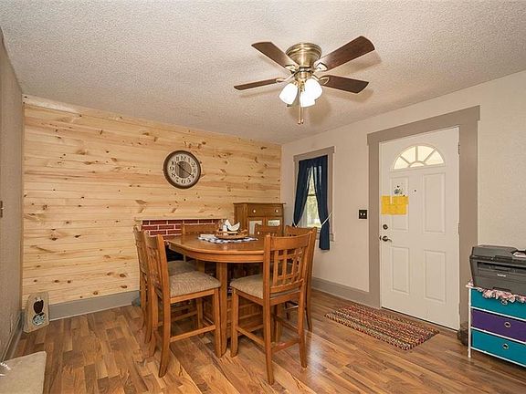 Dining room with fireplace and new flooring.