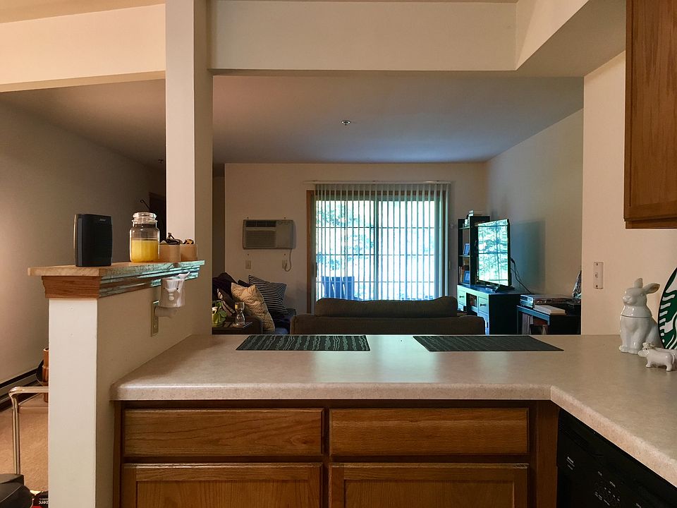 View of living room and patio from kitchen
