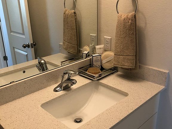 Bathroom vanity with an undermount sink, wide mirror, and generous counter space for daily essentials.