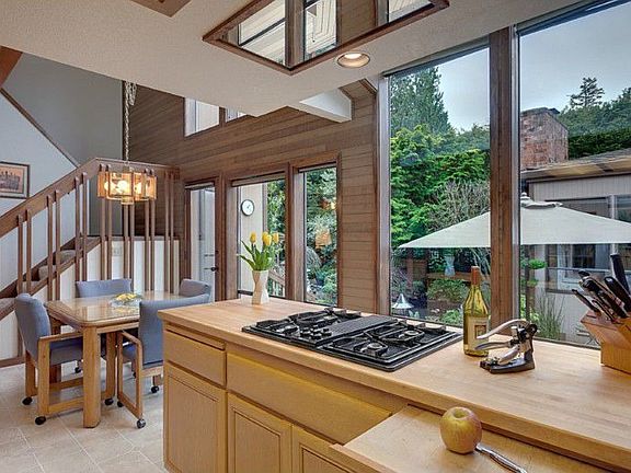 Kitchen with active viewing area adjacent to breakfast table and family room. Maple countertops and Jenn-air gas stove w/ downdraft vent make this chef's kitchen beautiful and functional.