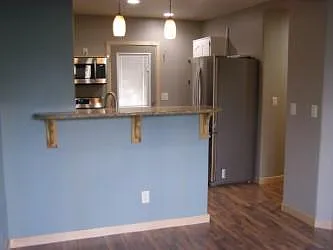View from living room into kitchen. Samsung fridge with built in ice maker.