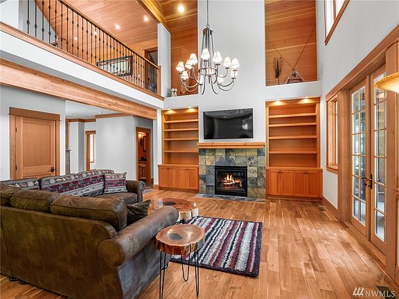 Great Room. Vaulted ceiling, built in cabinetry. Hardwood floors with French doors leading to the covered patio. 