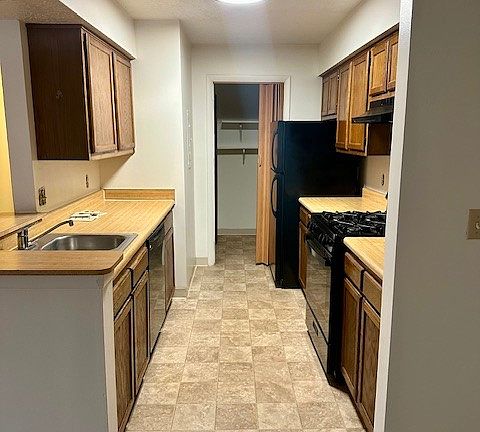 Galley style kitchen with all black appliances