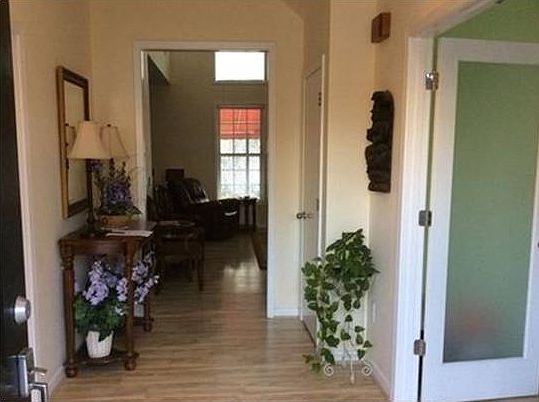 Two story foyer flanked by formal living and formal dining