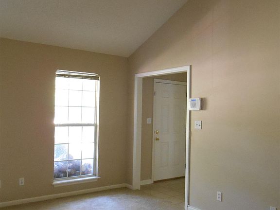 Living room view from kitchen to front door