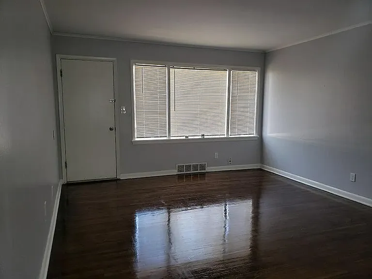 living room facing the back door that extends to the concrete patio in the backyard.