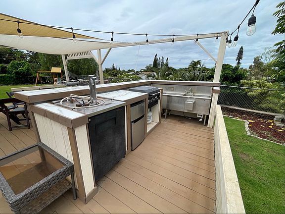 Outdoor living space with a keg fridge and wash station