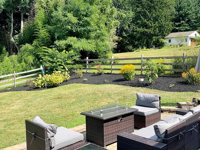 Backyard with patio furniture, grill, and propane fire pit. Perfect for watching all the wildlife!