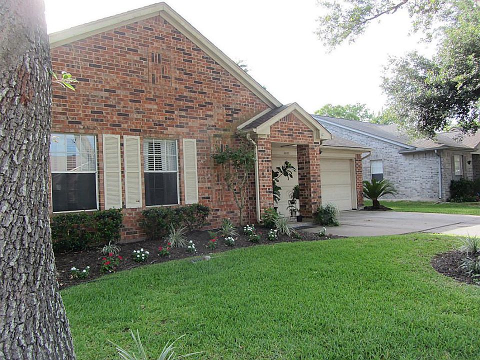Front of home features lush lawn & shade trees.