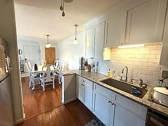 Bright lighting in kitchen, breakfast bar and dining area.