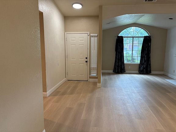 Open family room with fireplace.