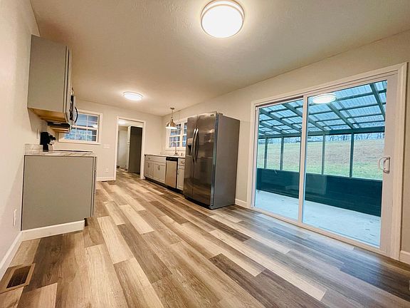 Sliding glass door to covered screened in back porch.