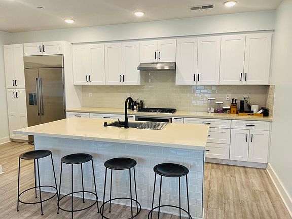 Kitchen gas cooktop stainless appliances with powder room bath