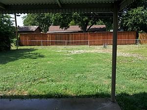 Covered Patio with large fenced in backyard
