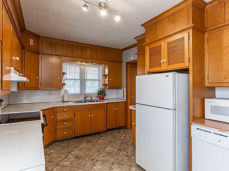 Kitchen with new appliances and solid wood cabinets.