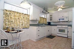 kitchen. built in sliding shelves in the pantry, pot rack, built in spice rack