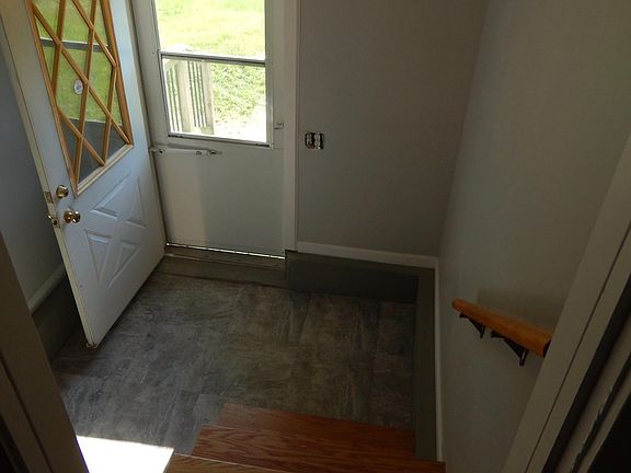 Freshly remodeled entryway; basement down stairs, to the left