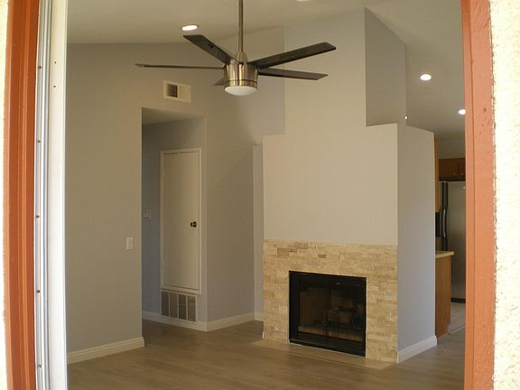 Recessed lights and ceiling fan keep living room bright and 