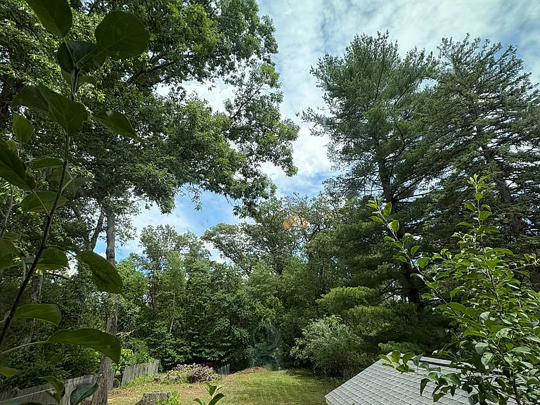 View of the backyard from the versatile second-floor flex room, ideal as a playroom, family room, or bonus living space.