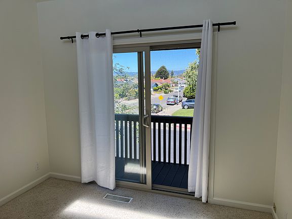2nd bedroom with private balcony and high ceiling