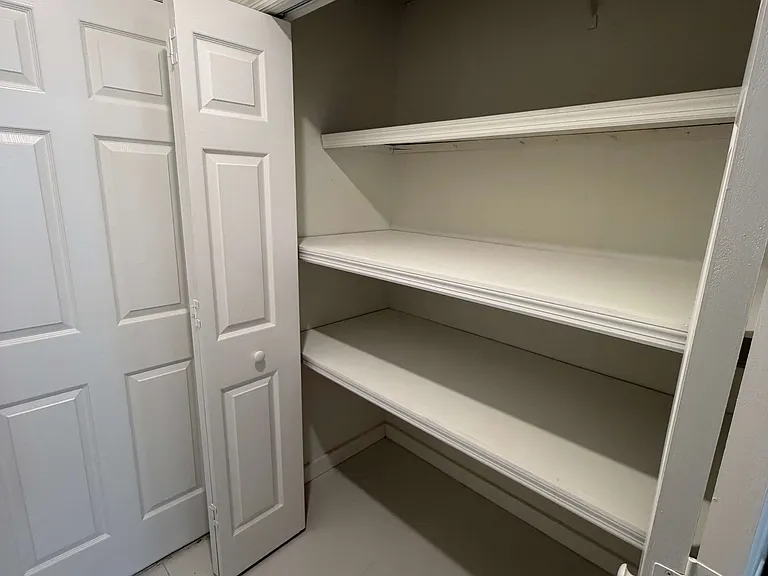 View the storage closet in the first floor bedroom / theater / office with ensuite bathroom as you enter from the garage