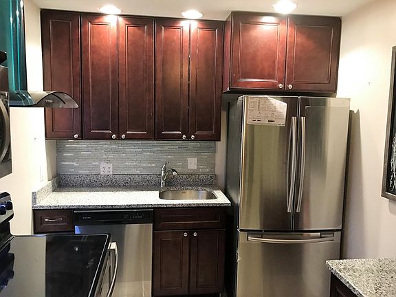 Designer kitchen with new appliances and granite countertops