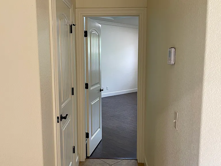 Behind door on left is large walk in storage closet. This hallway leads to the master bedroom.